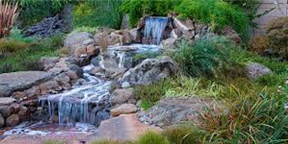 Small cascading waterfall in a natural garden setting